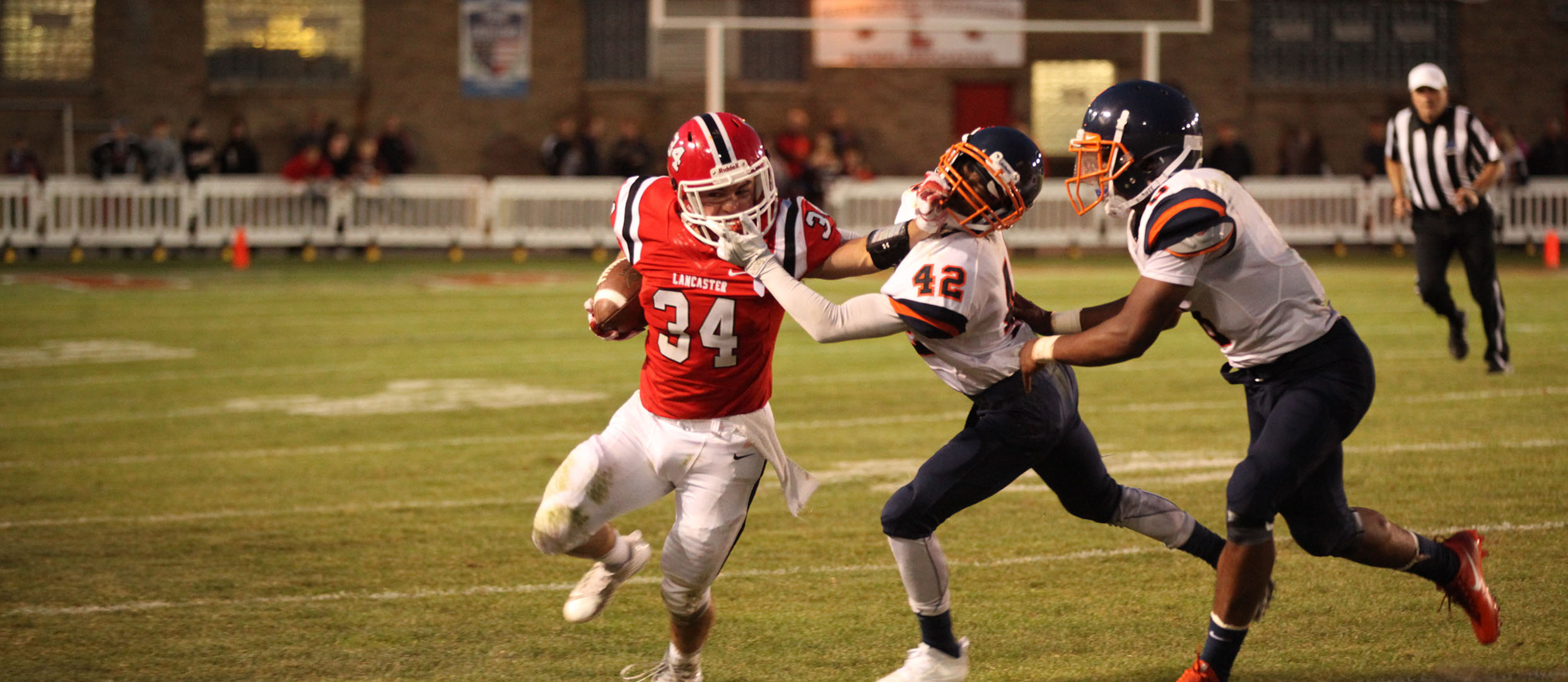 Lancaster Legend RB stiff arming the DB