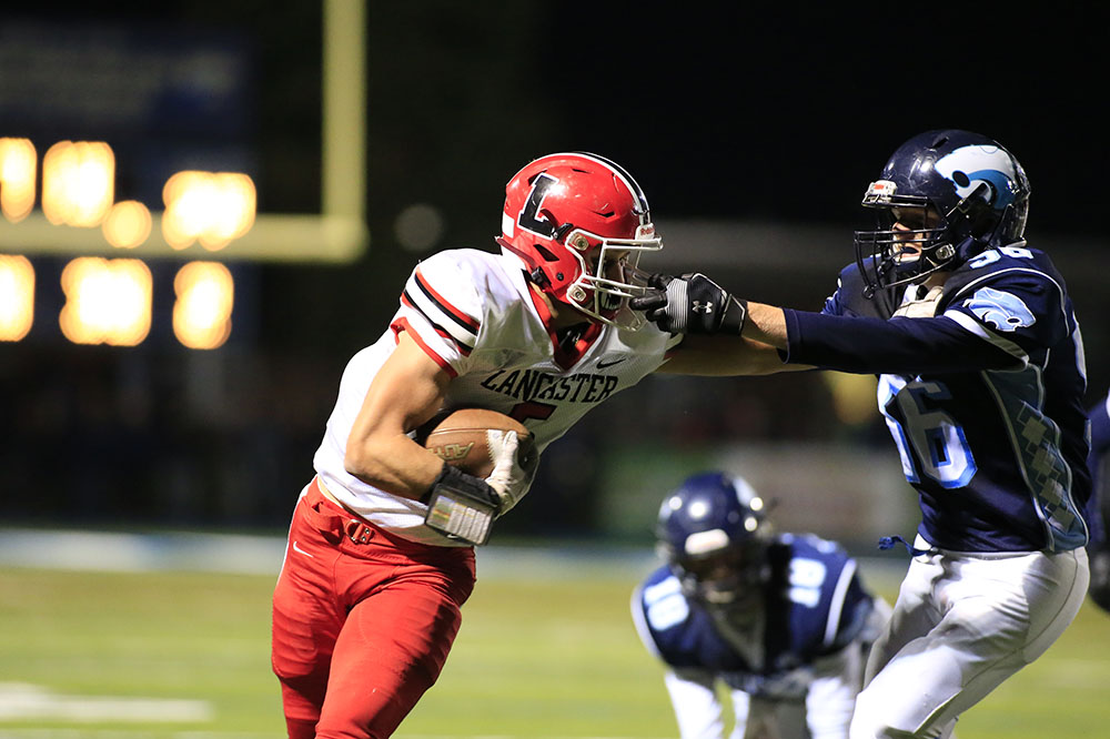 WR running the ball as he has his mask grabbed