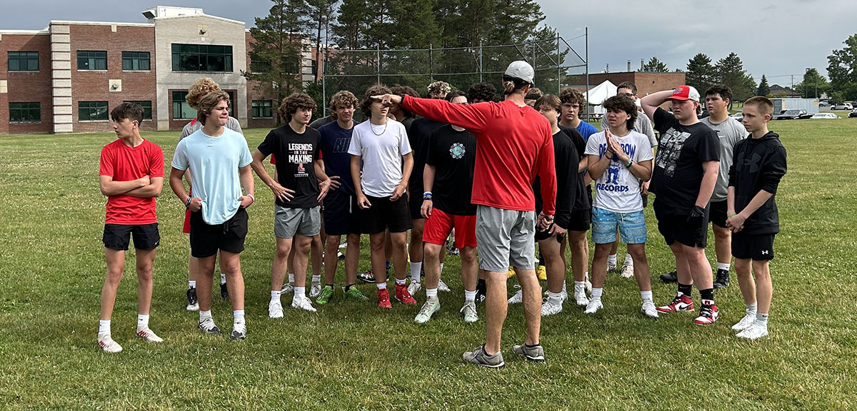 Coach going over instructions with Lancaster players