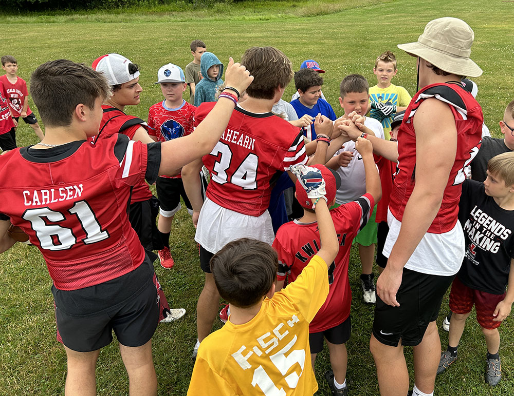 Young campers huddle up after the drill