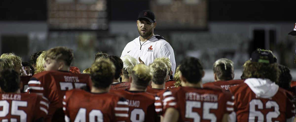 Coach Rupp speaking to the team after the win