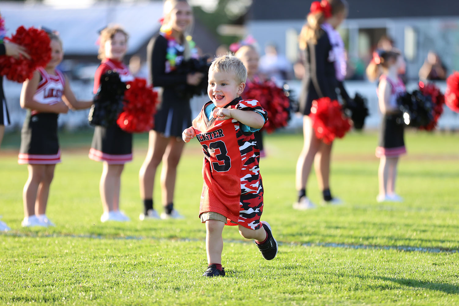 The smallest youth football player runningn the field