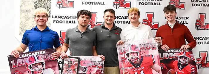 Lancaster players holding their banners