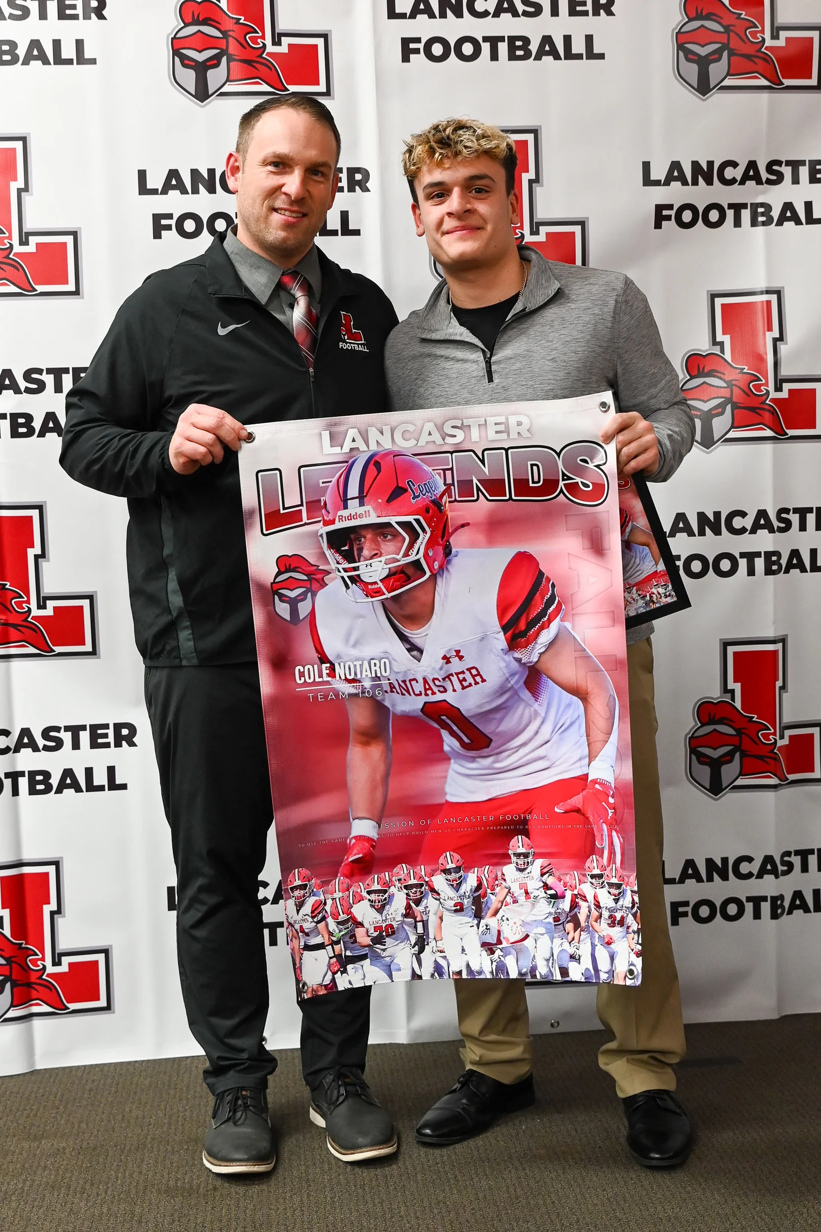Cole holding his banner with Coach Rupp