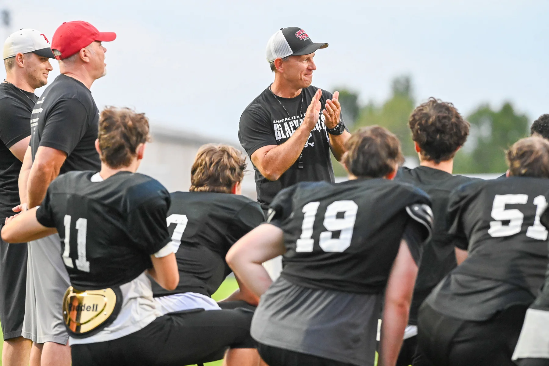 Coach Mansell clapping in the huddle
