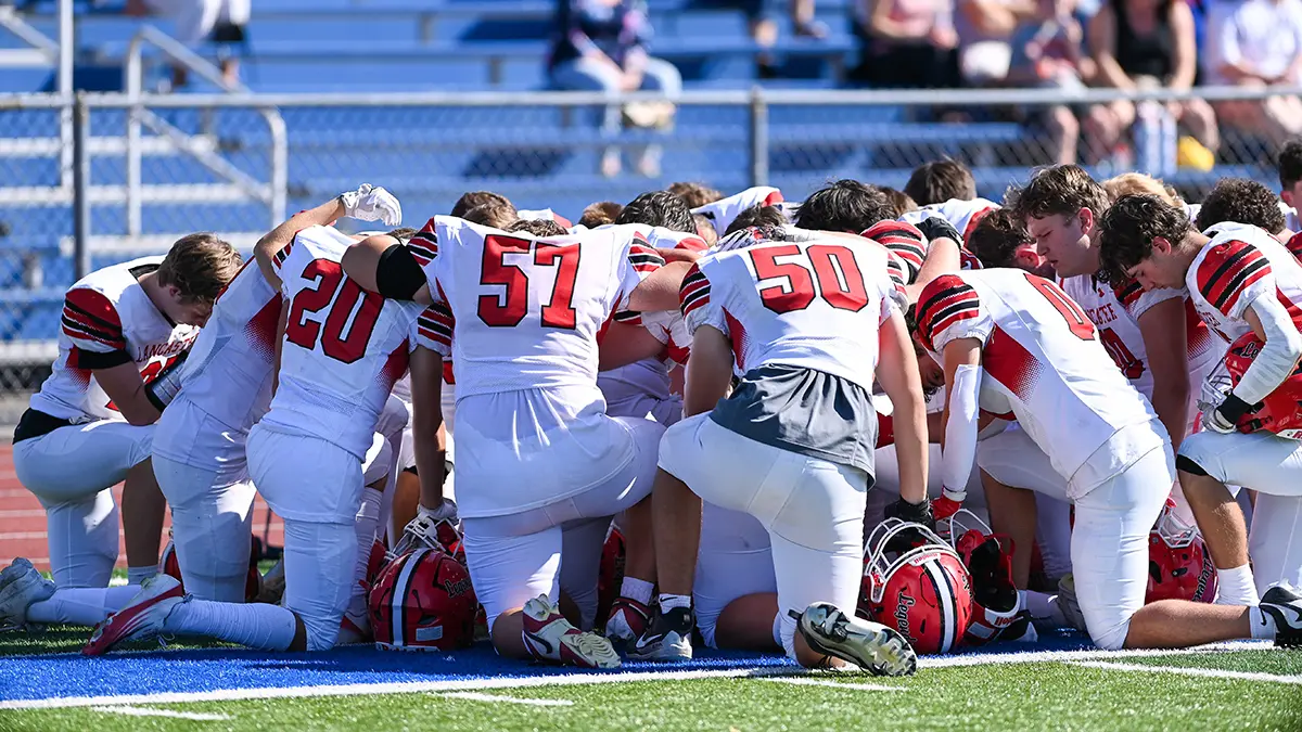 Lancaster players taking a knee prior to the game