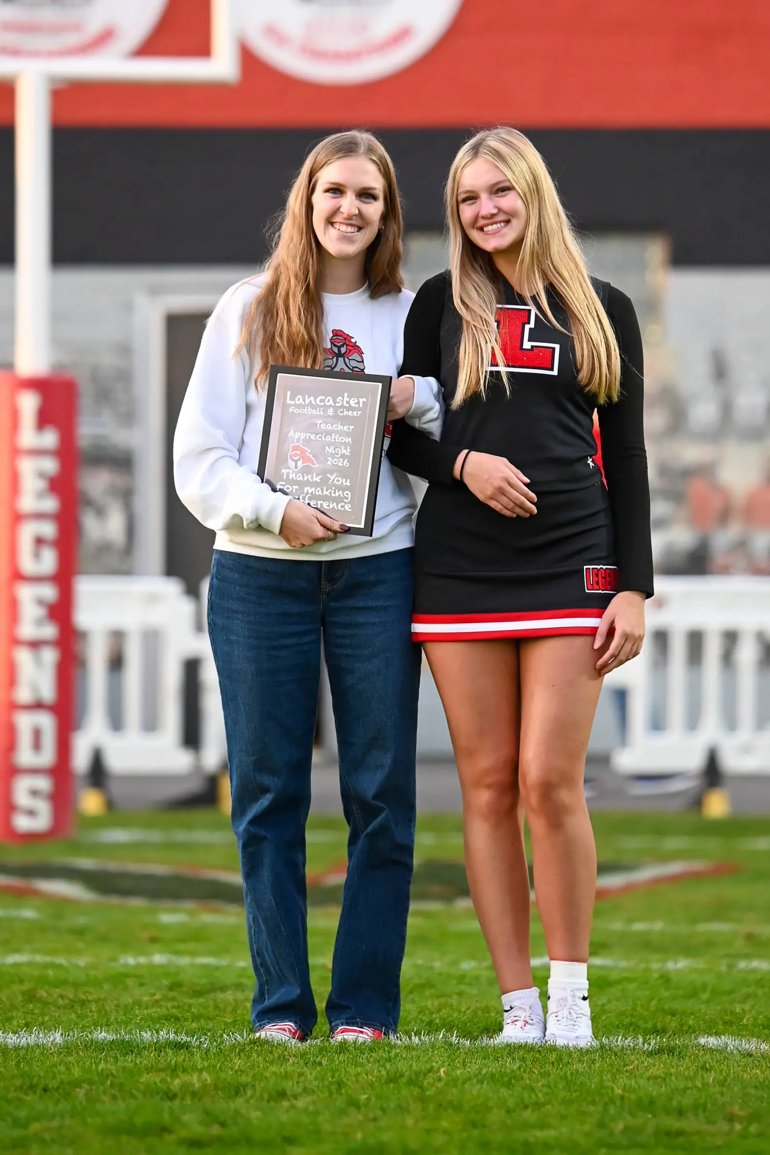 Smiling Cheerleader and Teacher on Teacher Appreciation Night